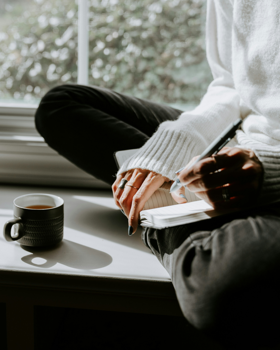 kelly-sikkema-photographer-clarity-sessions-a-reason-4-being woman sitting in window with tea and writing in journal